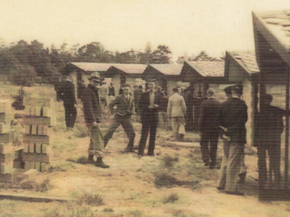 Camp Manyung people standing near huts