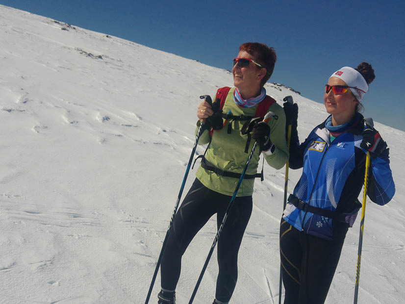 Two women standing with skis on Falls Creek cross country trail