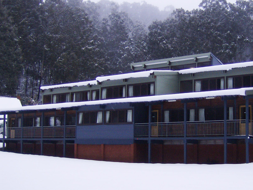 An accommodation wings at Howmans Gap Alpine Centre is covered in snow.