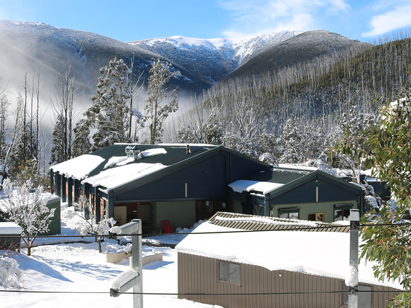 An exterior image of Howmans Gap Alpine Centre covered in snow during winter.