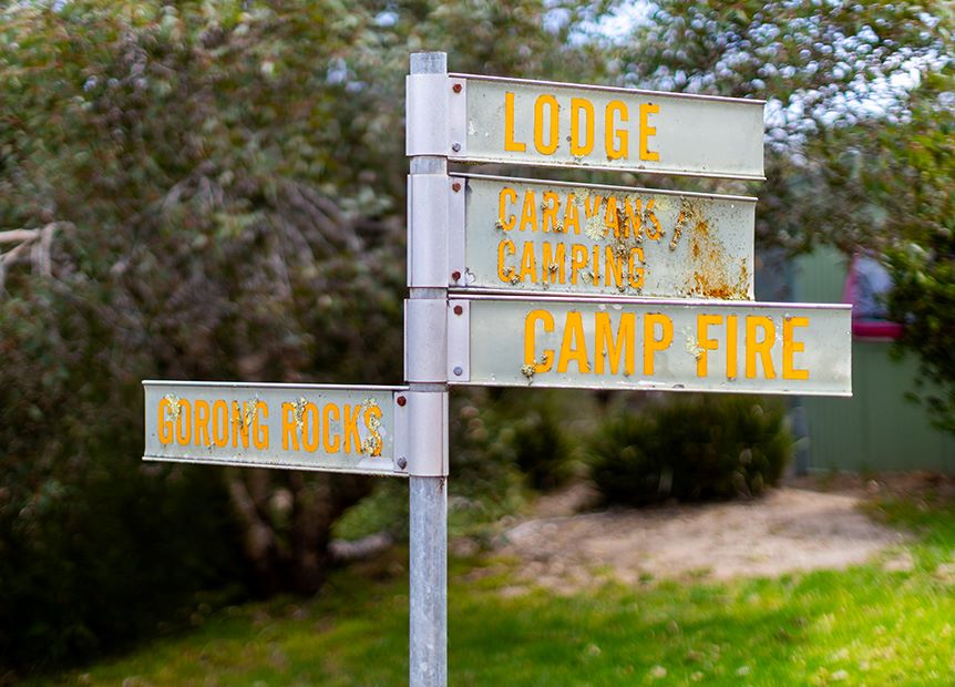 Signposts pointing to the lodge, caravan camping, camp fire and gorong rocks