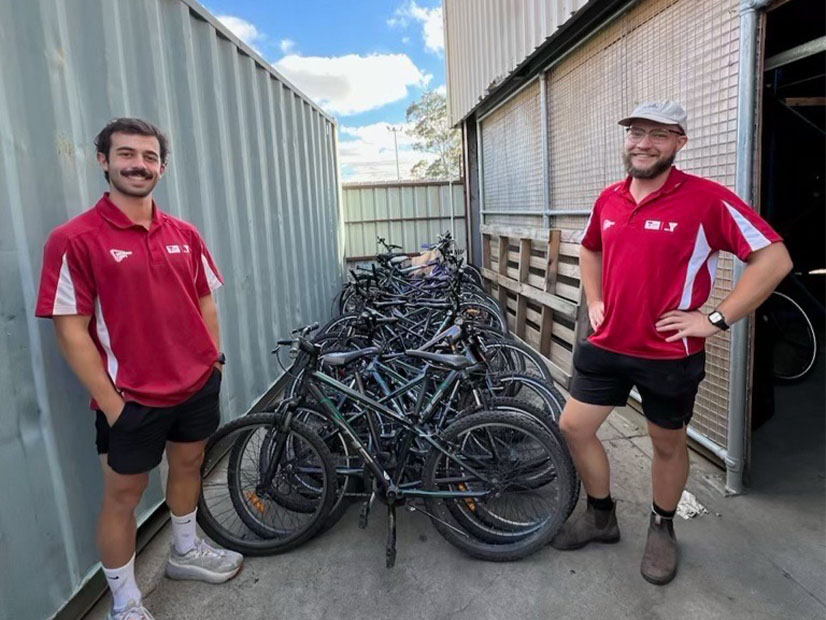 Staff members standing in front of bikes