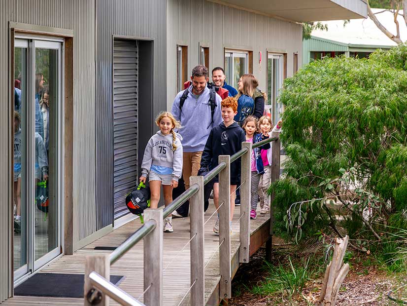 A family group leaving their accommodation