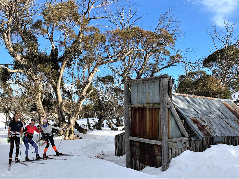 Skiers standing in front of Wallaces Hut Alpine National Park Falls Creek   